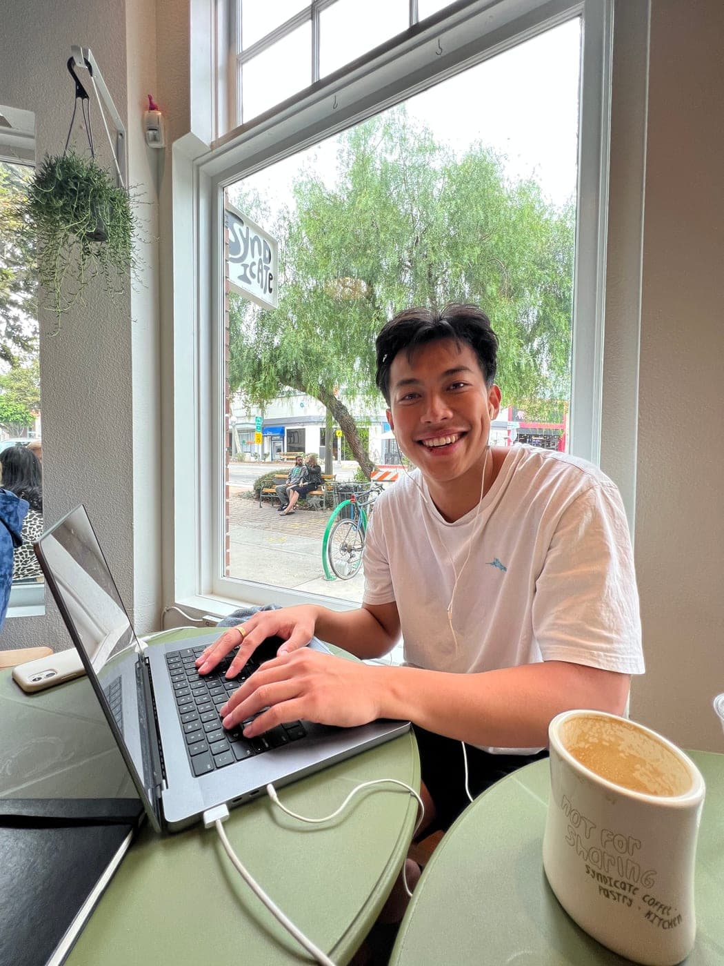 Will working on his laptop at a café