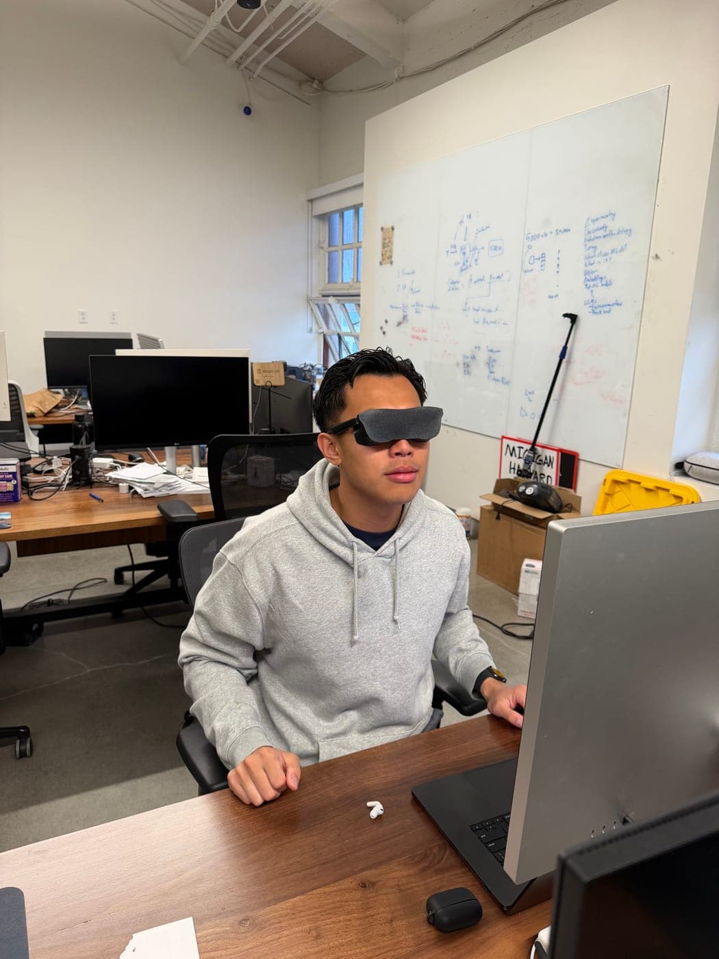 Will at his desk wearing a pair of video glasses